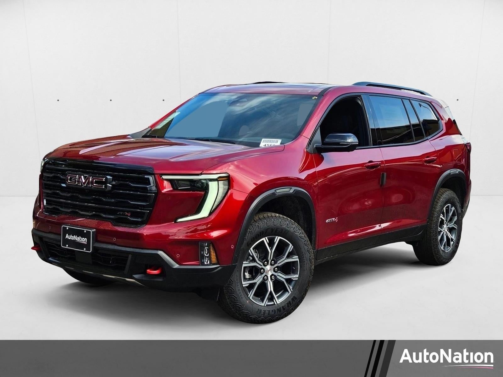 2026 GMC Acadia AT4 in Volcanic Red Tintcoat — front three-quarter view